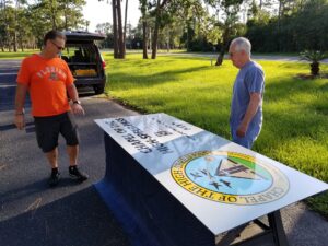 Jeff Strickland and Pat Geer (right) prep the new signs for installation at the Chapel of the High-Speed Pass